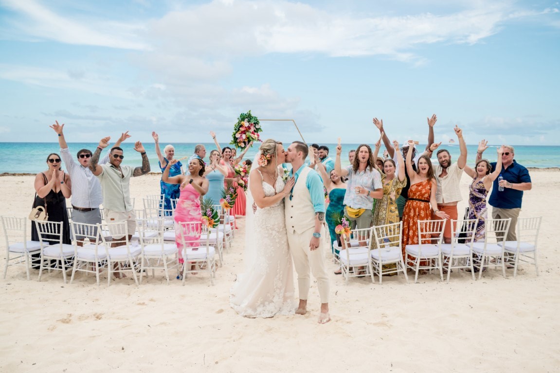 Couple celebrating their micro destination wedding with guests on the beach