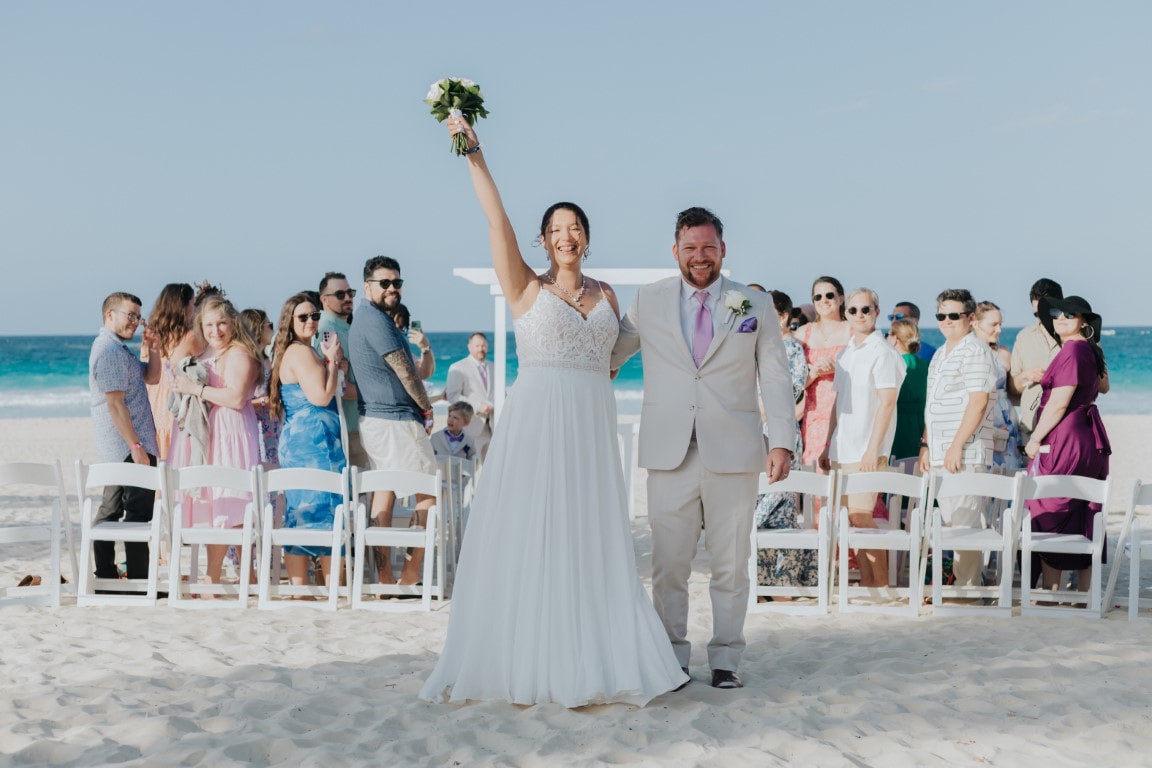 Bride and groom celebrating with a smaller destination wedding guest group