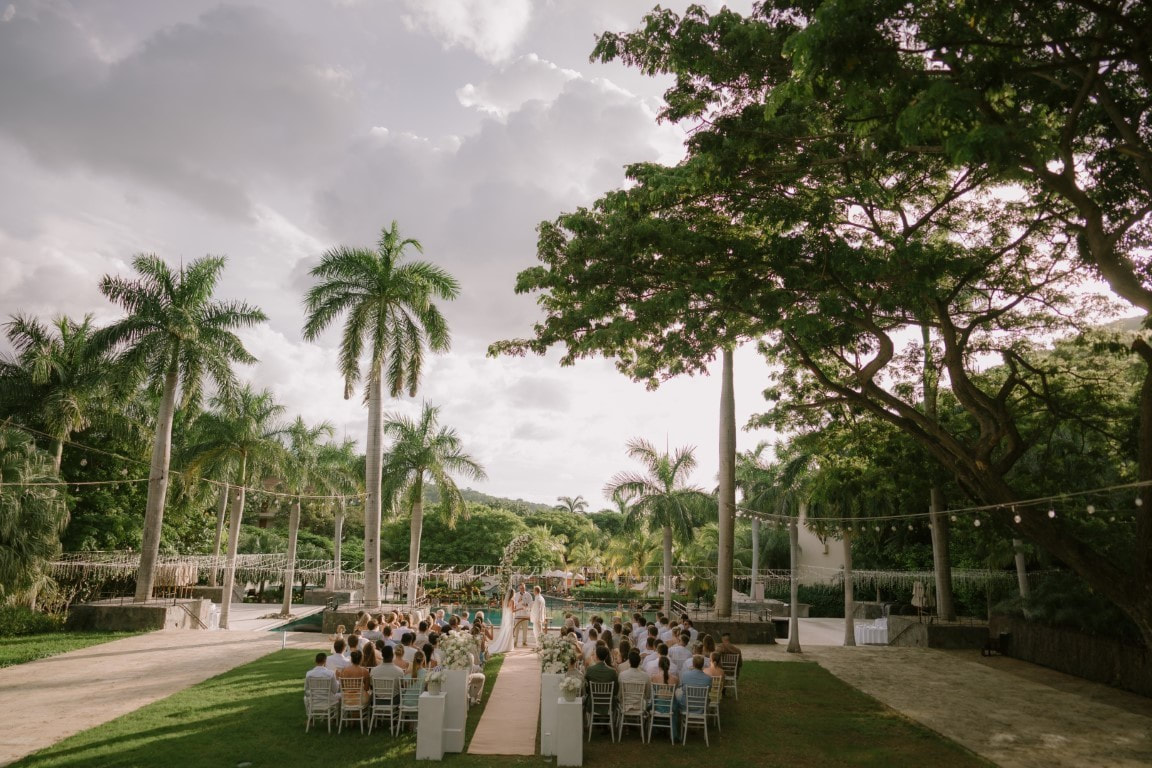 Outdoor destination wedding ceremony in a tropical garden setting