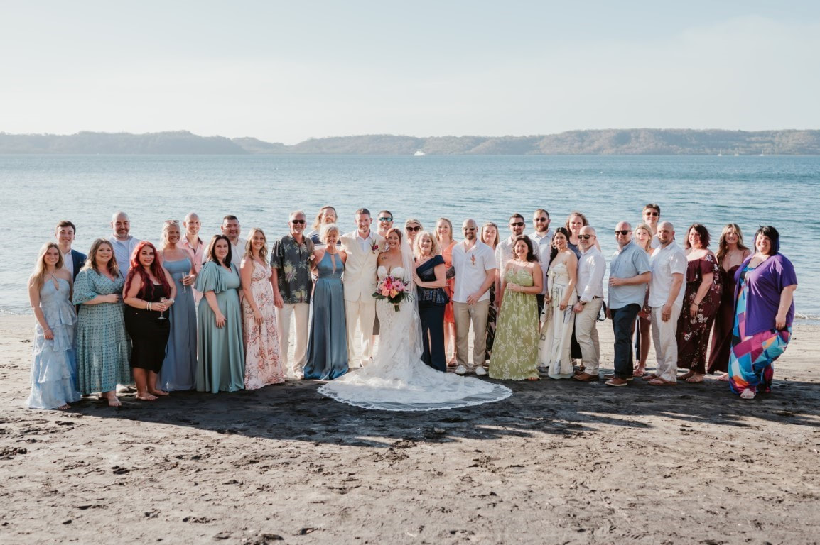 Small destination wedding group photo on the beach