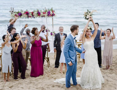 Wedding party cheering during destination wedding ceremony