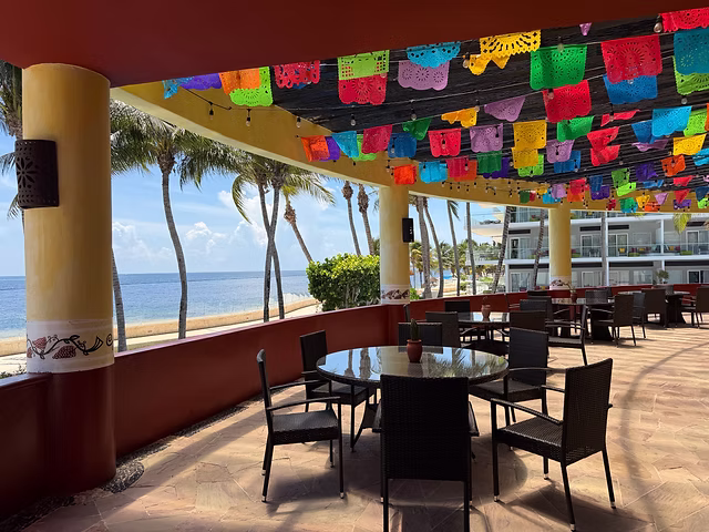 Oceanfront restaurant terrace with colorful papel picado decorations