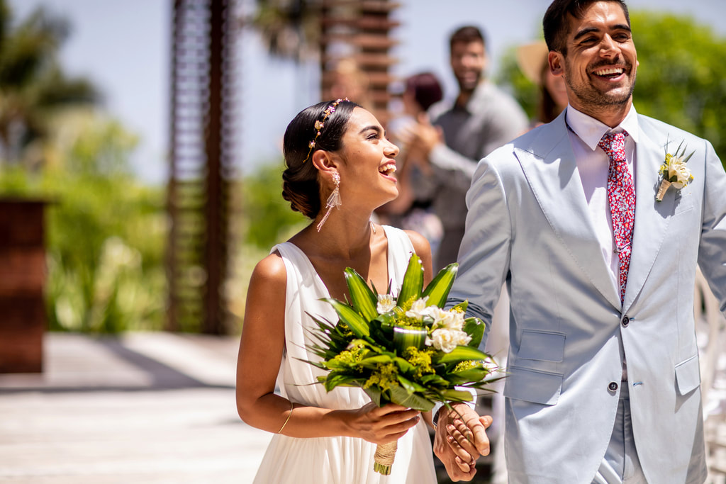 Destination wedding couple smiling during ceremony entrance