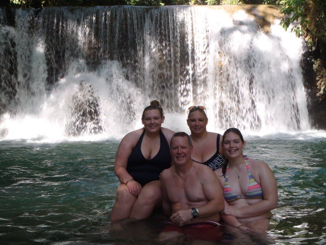 Heather and family in front of waterfall
